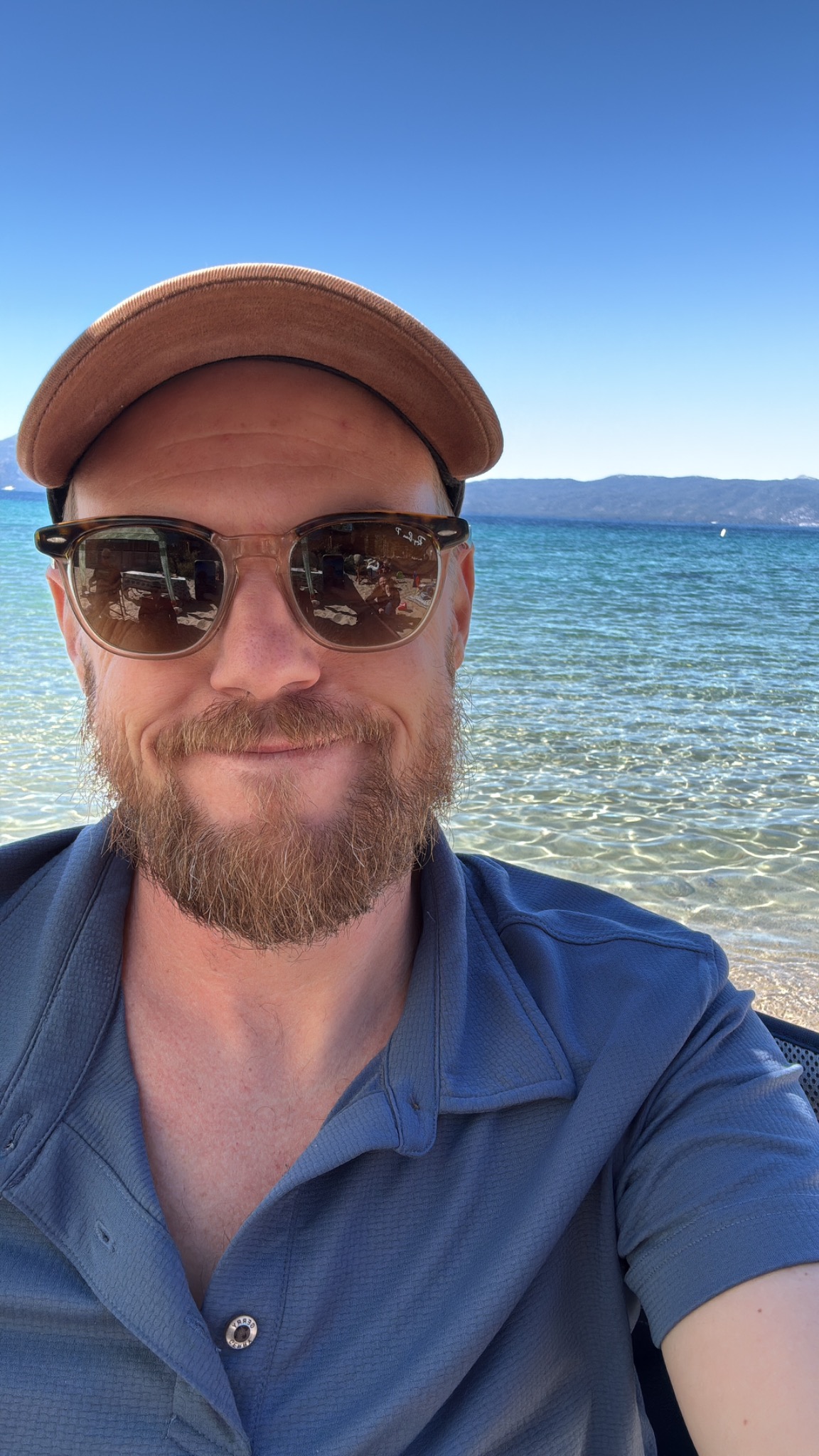 Dylan outdoors beside the clear water of Lake Tahoe